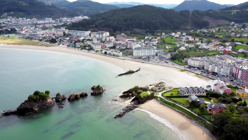 Panoramic aerial view of beautiful country side of Galicia - Spain. View of Covas city, in background is the city of Viveiro. Beautiful landscape with green fields and mountains full with trees. 