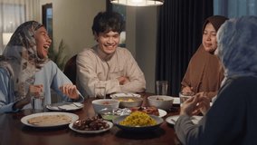 Happy Asia muslim parent and their kids Ramadan dinner together in dining room at home. Family of two generation catering celebration end of Eid al-Fitr togetherness at home. Hari Raya family reunion. - Powered by Shutterstock - Get 15% off with code: PIKWIZARD15