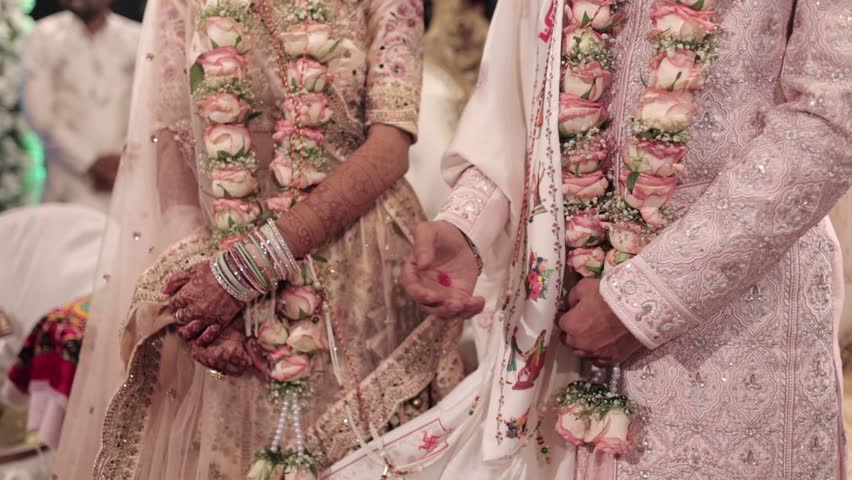 Indian Hindu Couple holding each other hands during their marriage Function.  couple performing Seven Vows of Hindu Marriage . Close up slow motion Video. Royalty-Free Stock Footage #1101034517