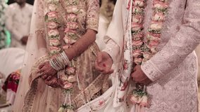 Indian Hindu Couple holding each other hands during their marriage Function.  couple performing Seven Vows of Hindu Marriage . Close up slow motion Video.