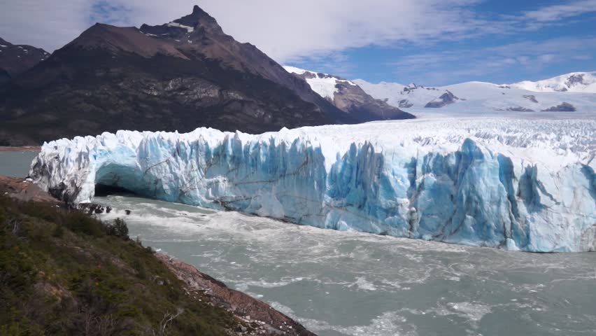 almost complete panoramic view of the Perito Moreno Glacier bathed by the Lake. Climate change and global warming Royalty-Free Stock Footage #1101037931