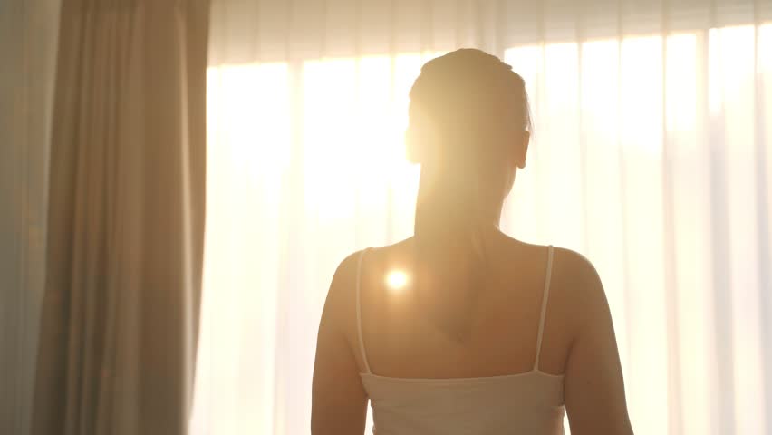 Woman is stretching muscles in front of the window in the morning. | Shutterstock HD Video #1101039345