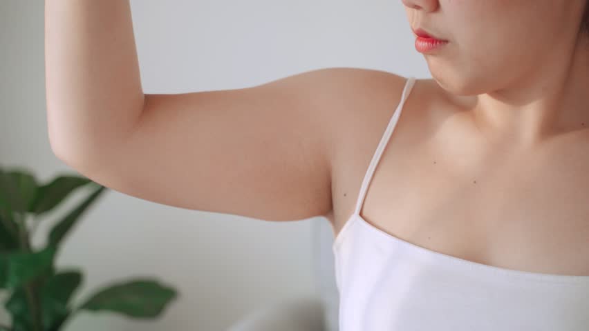 Close up of Chubby woman pinching upper arm fat. weight loss concept. | Shutterstock HD Video #1101039353