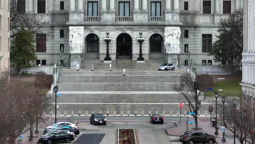 Pennsylvania capitol building as seen from State Street, Harrisburg. Long aerial zoom with rising motion.