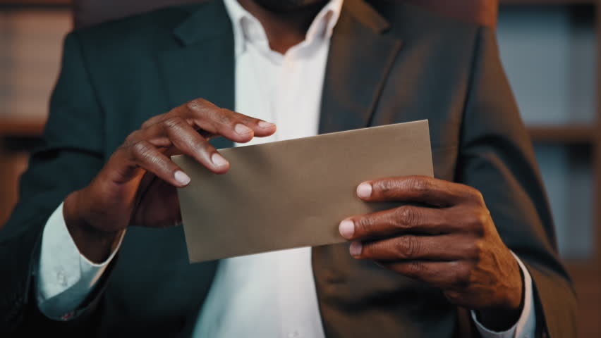 Serious african american businessman sitting at home office opening paper letter upset disappointed man read bad news receives notification with refusal of bank loan frustrated by bankruptcy dismissal Royalty-Free Stock Footage #1101042685