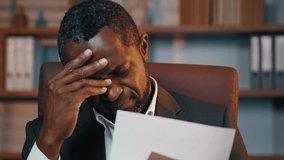 Serious african american businessman sitting at home office opening paper letter upset disappointed man read bad news receives notification with refusal of bank loan frustrated by bankruptcy dismissal - Powered by Shutterstock - Get 15% off with code: PIKWIZARD15
