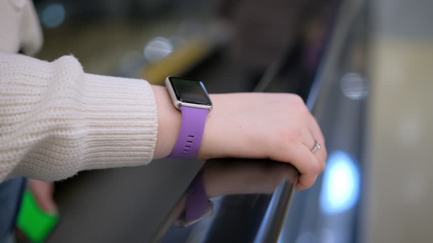 Moll. A young woman in a shopping mall stands on an escalator. 4K