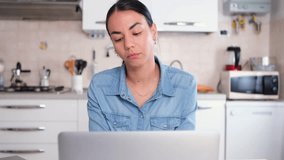 Video about woman working from home using laptop