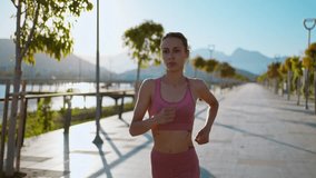 Portrait of fitness healthy woman running on road at promenade. Jogging workout wellness concept - Powered by Shutterstock - Get 15% off with code: PIKWIZARD15