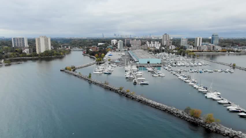 Aerial shot flying along a harbor on Lake Ontario in Mississauga in the early morning.
