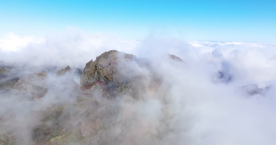 Clouds In The Mountain Peak Pico do Arieiro In Highlands Of Madeira, Portugal - aerial drone shot