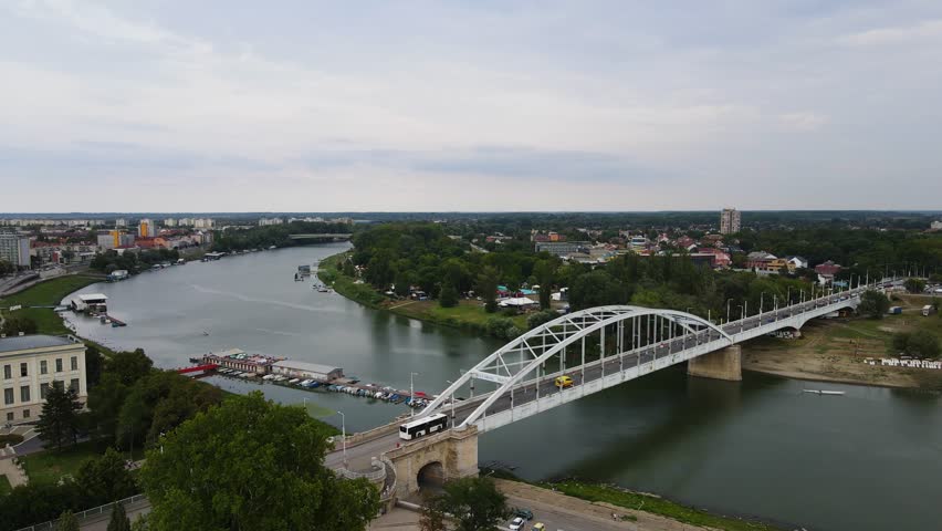Aerial establishing view of Belvárosi Bridge over Tisza River, Szeged, Hungary.