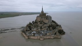 Mont Saint Michel during low tide, Normandy in France. Aerial orbiting