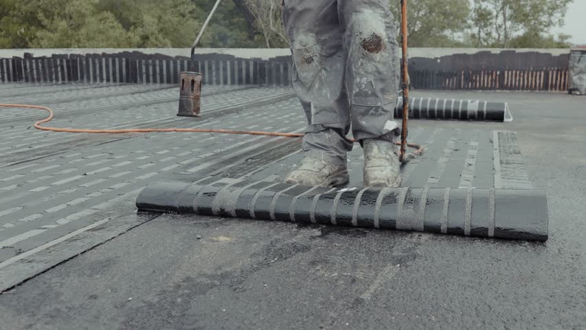Industrial flat roofing waterproofing system, installed by professionals with a fire burner Royalty-Free Stock Footage #1101052431
