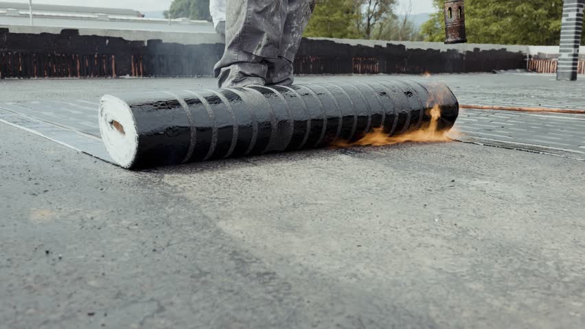 Industrial flat roofing waterproofing system, installed by professionals with a fire burner Royalty-Free Stock Footage #1101052433