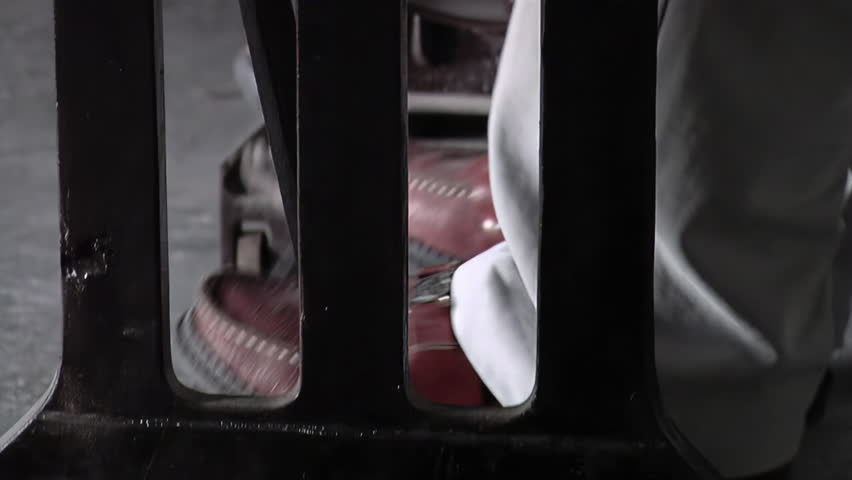 Legs of a Man Working with an Old Sewing Machine. Low Angle View. Close Up.  