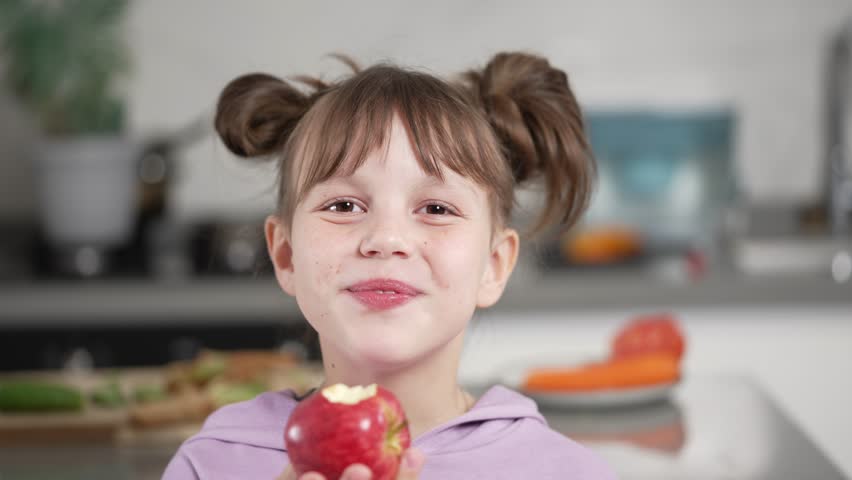Portrait of a Little Girl Eating an Red Apple Royalty-Free Stock Footage #1101058385
