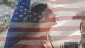 Animation of flag of usa over smiling caucasian woman on beach. American patriotism and diversity concept digitally generated video.