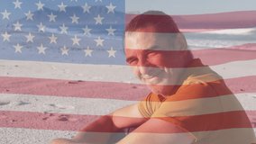 Animation of flag of usa over smiling caucasian man on beach. American patriotism and diversity concept digitally generated video. - Powered by Shutterstock - Get 15% off with code: PIKWIZARD15