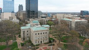 Aerial establishing shot of the North Carolina State Capitol. The North Carolina State Capitol is located in the state capital of Raleigh on Union Square at One East Edenton Street