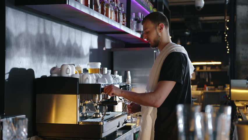 Barista washes a glass with steam on a professional coffee machine. slow motion. High quality 4k footage | Shutterstock HD Video #1101061151