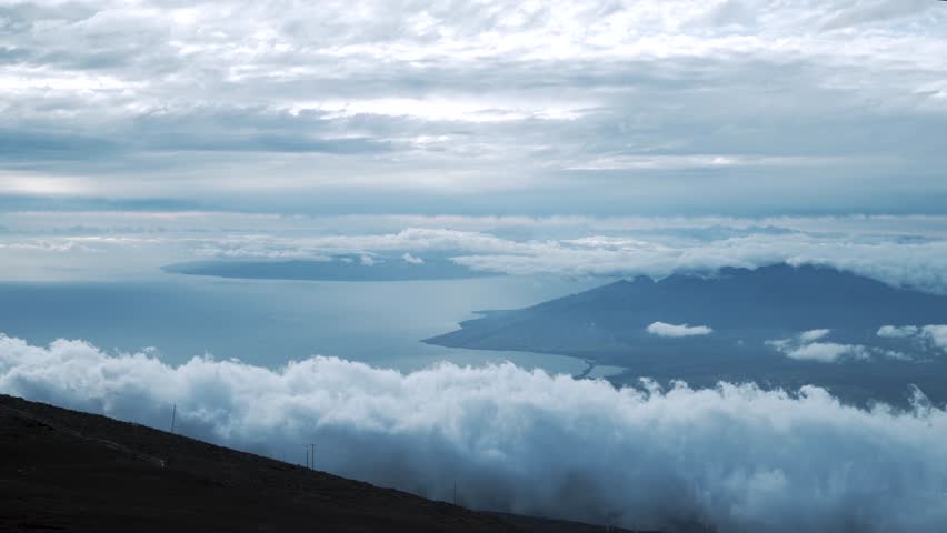Fast clouds at the Haleakala Crater. It looms 10,023 feet above the Pacific Ocean, taking up three-quarters of Maui’s 727 square miles. Haleakala sunrise inspires 1.5 million visitors annually.