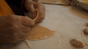 Closeup footage making tortelli stuffed with pumpkin filling homemade ravioli pasta, grandma cook seasonal 'tortelli di zucca.