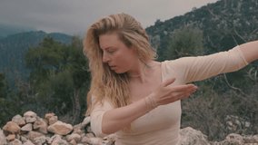 contact improvisation. girl dancing on the street against the backdrop of mountains and forests. improvisation in dance.