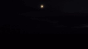 Car headlights under hazy crescent moon driving behind hill - Powered by Shutterstock - Get 15% off with code: PIKWIZARD15