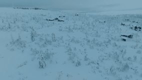 Drone shot of small village Saariselka in Finland in winter. Sami village. Urho Kekkonen National Park. Kaunispää Triangulation Tower. Ski resorts. Walk in Saariselka. Frozen trees in Finland. Sunset. - Powered by Shutterstock - Get 15% off with code: PIKWIZARD15