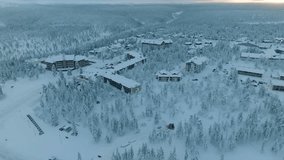 Drone shot of small village Saariselka in Finland in winter. Sami village. Urho Kekkonen National Park. Kaunispää Triangulation Tower. Ski resorts. Walk in Saariselka. Frozen trees in Finland. Sunset. - Powered by Shutterstock - Get 15% off with code: PIKWIZARD15
