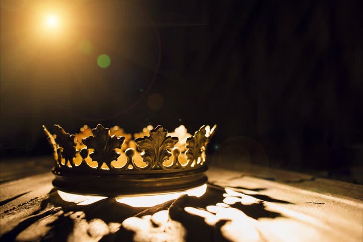 The crown on a black background is illuminated by a golden beam. Low-key image of a beautiful queen  royal crown Vintage is filtered. Fantasy of the medieval period. Battle for the Throne. Royalty-Free Stock Footage #1101071705