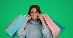Woman, shopping bags and smile for fashion, discount or sale against a green studio background. Portrait of happy female shopper smiling in joyful happiness for stylish clothing gifts on mockup