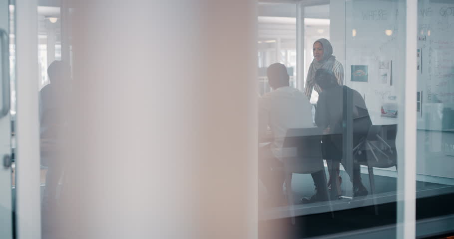 Happy, celebrating and clapping corporate team after a successful business planning meeting. Diverse group of businesspeople sitting and listening to a muslim manager in the boardroom at the office. | Shutterstock HD Video #1101072405