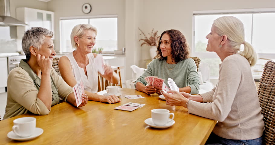 Senior people, retirement and playing cards with funny communication for holiday free time together at home table. Excited elderly group of people with card games talking, debate and chat rules Royalty-Free Stock Footage #1101072449