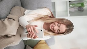 Vertical video of amazed lucky woman extremely happy after read message in mobile phone at home Excited blond female looking at screen and pleased rejoices received great news on smartphone indoors - Powered by Shutterstock - Get 15% off with code: PIKWIZARD15