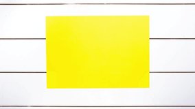 Yellow paper wrinkles making a paper ball and a blank sheet on white wooden background with copy space. Stop Motion video available for both vertical and horizontal use.
 - Powered by Shutterstock - Get 15% off with code: PIKWIZARD15