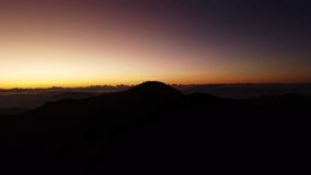 Aerial video of Mount Pulag at sunset with people in the background, the third highest mountain in the Philippines