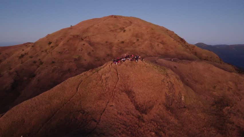 Aerial video of Mount Pulag at sunset with people in the background, the third highest mountain in the Philippines