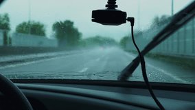 Windshield Flooded With Rain View From Inside The Car. DVR Captures The Traffic Situation. Windshield Wiper Sweeps Away Raindrops On The Glass. Poor Visibility On Wet Slippery Road. Heavy Rain. - Powered by Shutterstock - Get 15% off with code: PIKWIZARD15