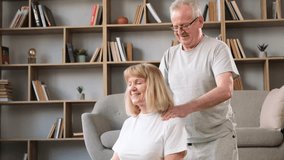 A gray-haired grandfather gives a neck massage to his grandmother. Happy senior married couple  - Powered by Shutterstock - Get 15% off with code: PIKWIZARD15