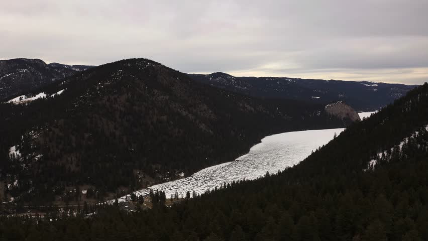 Captivating Winter Scenery of Paul Lake Surrounded by Majestic Evergreen Forests, Inviting You to Embrace Serenity and Tranquility in Kamloops, British Columbia