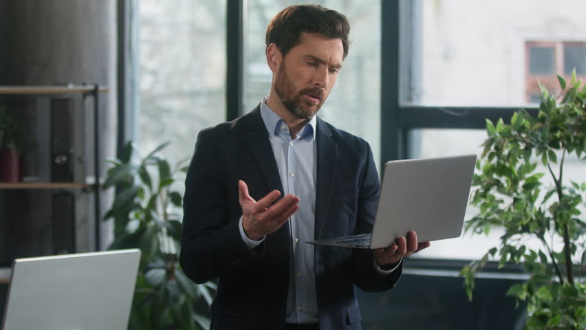 Upset caucasian man in office using laptop feel frustrated failed stressed about mistake software error data loss businessman manager corporate employee leader reading bad news online worried problem Royalty-Free Stock Footage #1101083657