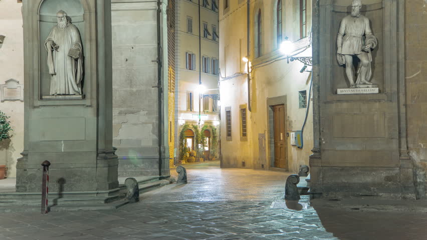 Statues at Uffizi Gallery and street timelapse. Prominent art museum located adjacent to Piazza della Signoria in central Florence, region of Tuscany, Italy. Night illumination on the old streets