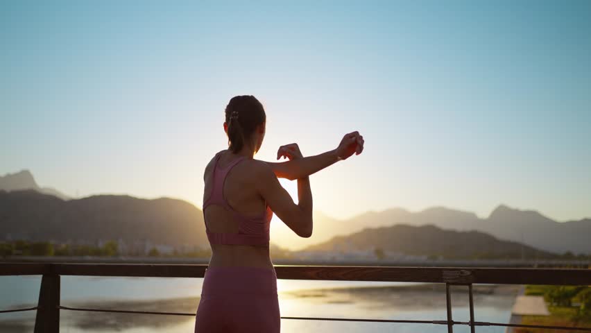 New normal sport outdoor, young fit sport woman stretching her body warm up before workout outdoor. The girl in sportswear exercises outside in the evening sunset for health and wellbeing. Royalty-Free Stock Footage #1101092281