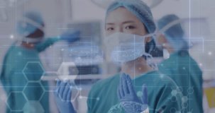 Animation of medical data processing over portrait of asian female surgeon in operating theatre. Medical and healthcare services concept digitally generated video.