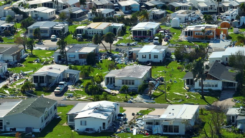 Severely damaged by hurricane Ian houses in Florida mobile home residential area. Consequences of natural disaster