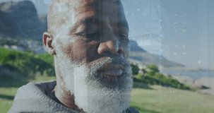 Animation of data processing over close up of african american senior man wearing earphones outdoors. Sports and fitness technology concept