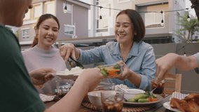 Mom enjoy thai meal cooking for family day home dining at dine table cozy patio. Mum passing serving food to group four asia people young adult man woman friend fun joy relax warm night picnic eating. - Powered by Shutterstock - Get 15% off with code: PIKWIZARD15