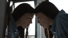 Woman looking at herself in bathroom mirror. Motivational concept of person staring at mirror reflection - Powered by Shutterstock - Get 15% off with code: PIKWIZARD15